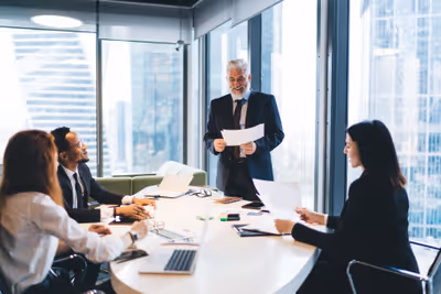 Modern business office environment with employees working on computers, representing professional IT services and cybersecurity solutions for Vermont businesses